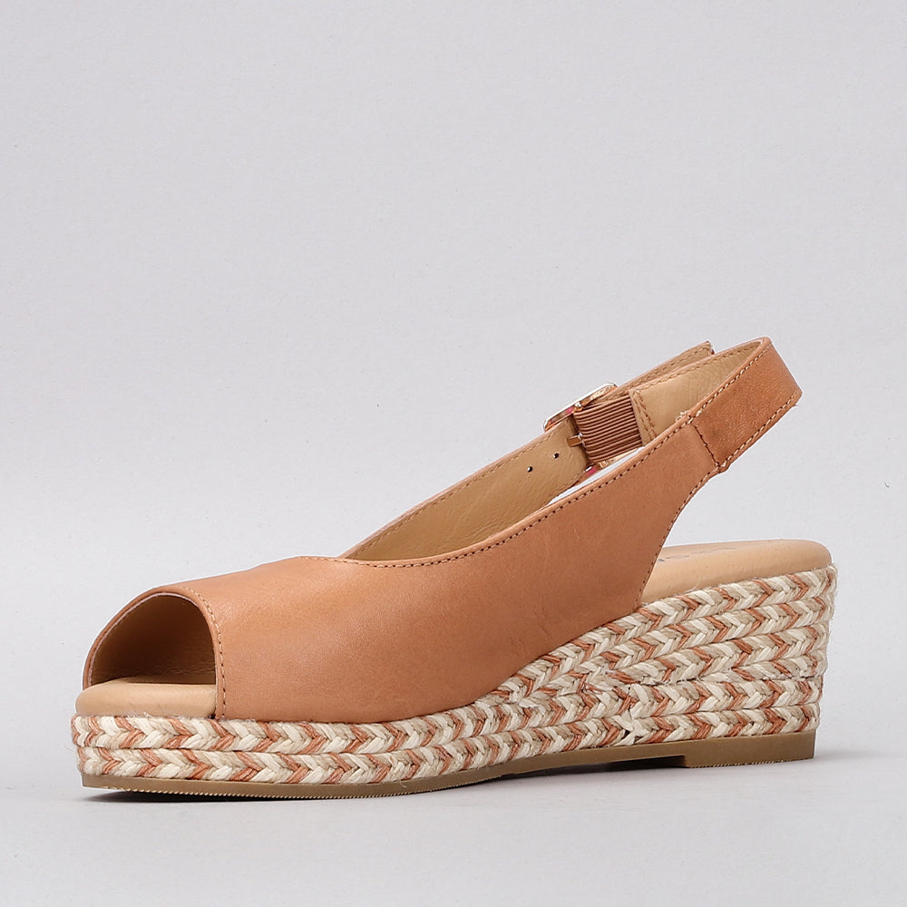 Le Sansa Dove Tan sandals featuring smooth leather straps and a flat sole, perfect for casual summer wear.