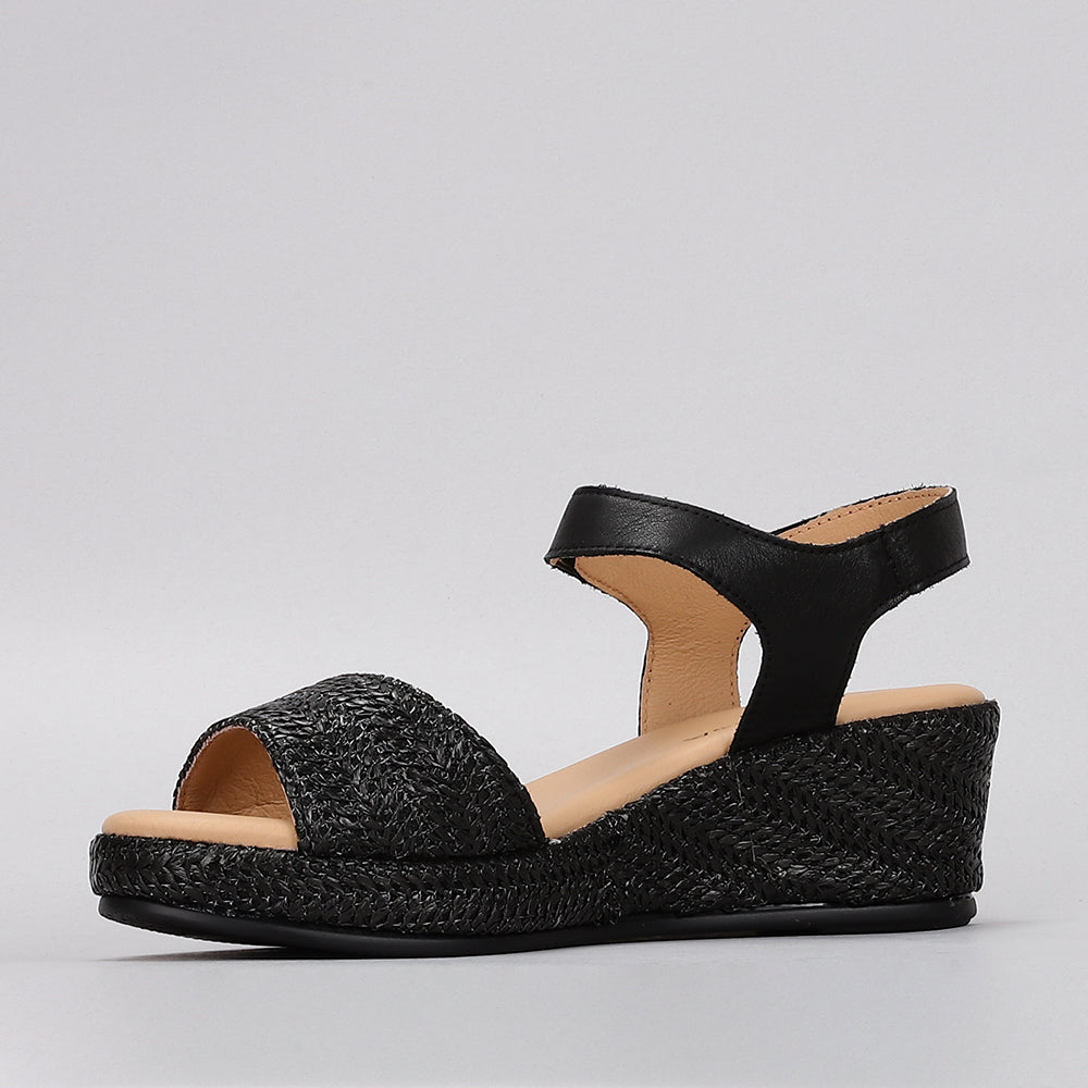 Black Le Sansa Sansa Pilia sandals with open toe design and ankle strap, displayed on a neutral background.