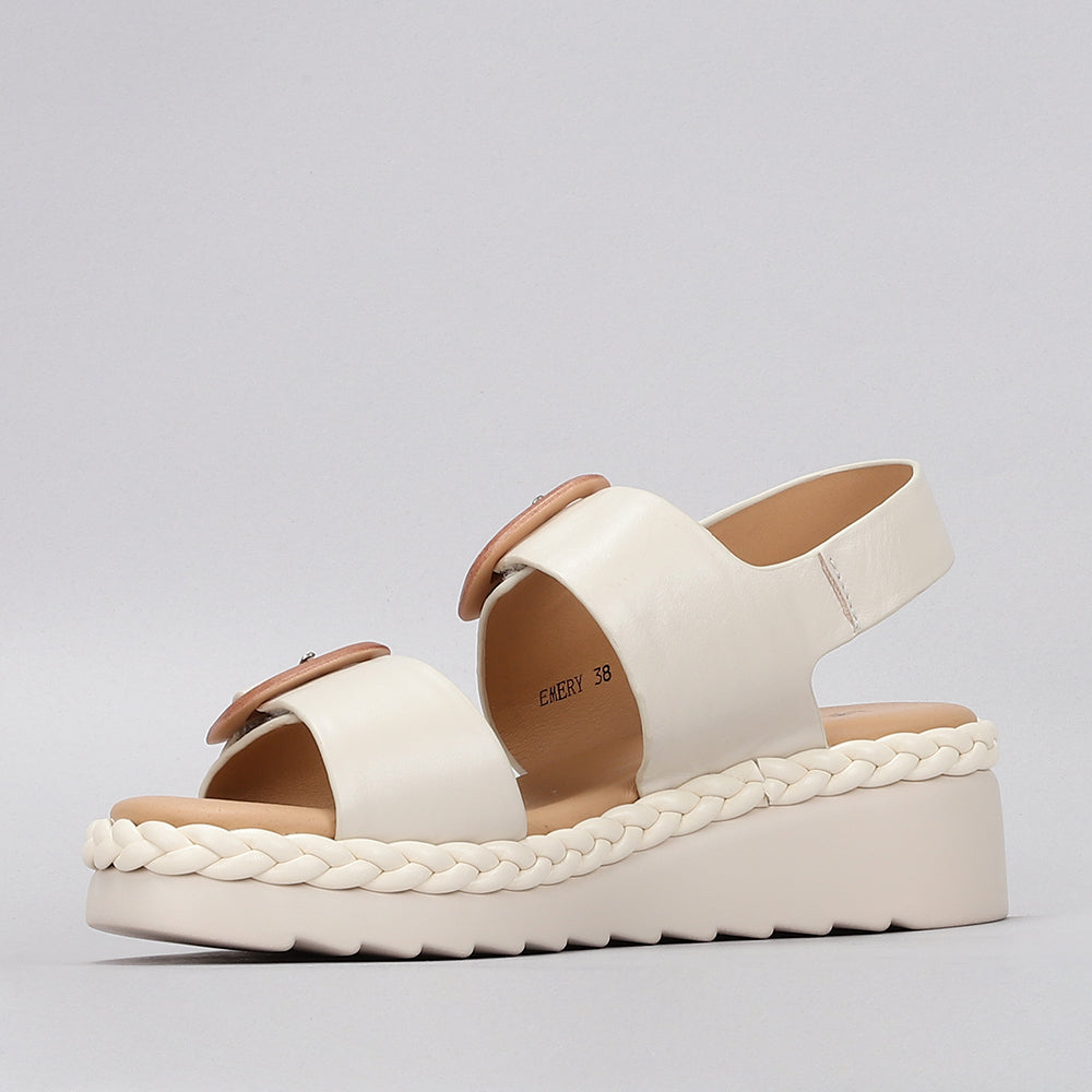 Le Sansa Emery Bone sandals featuring open toes, ankle straps, and a sleek design in neutral bone color.