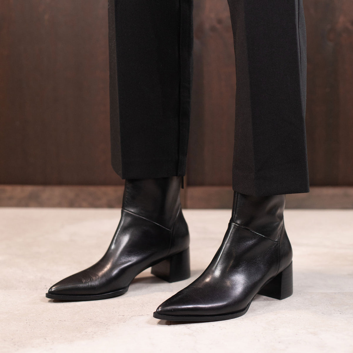 Eos Auroa Black boots featuring sleek black leather with stylish stitching and a comfortable ankle-high design.