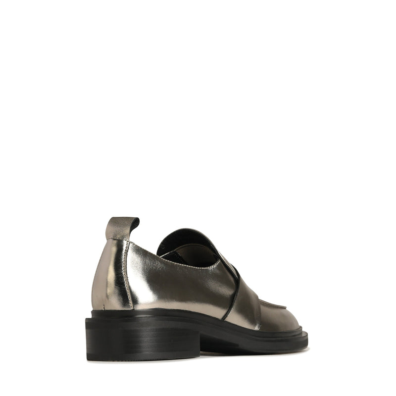 Eos Coia pewter metal loafers shown from a back angle, featuring sleek design and metallic finish.
