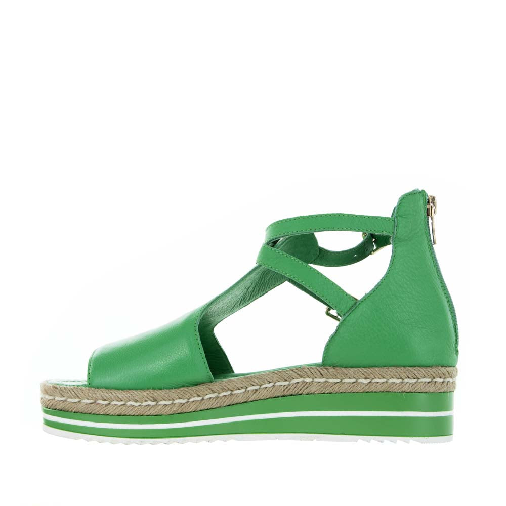 Django & Juliette Alexys emerald sandals with open toe design, ankle strap, and block heel on neutral background.