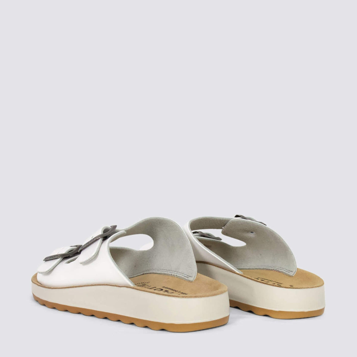 White Fly Flot flats with rounded toe and comfortable slip-on design, showcased from a side angle.