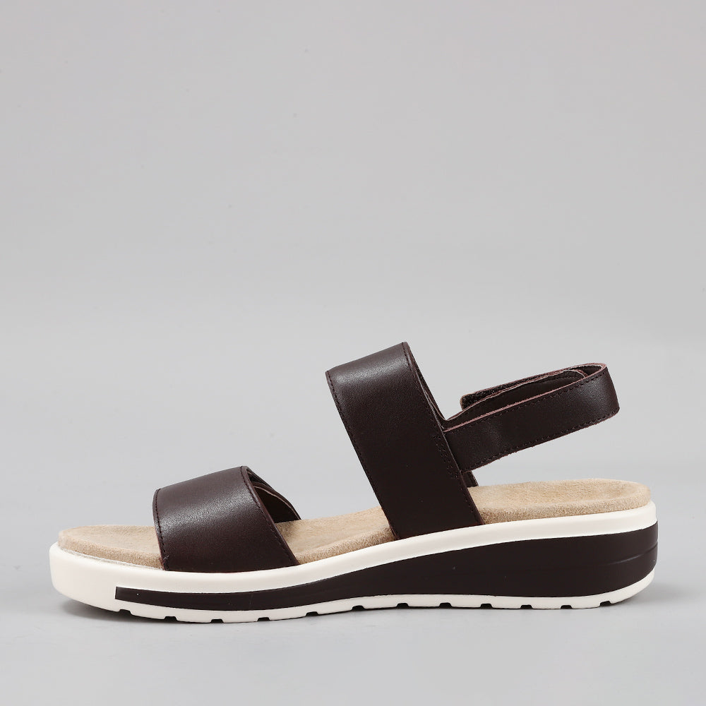 Naked Arches Hanza Chocolate sandals with brown leather straps and cushioned footbed on a neutral background.