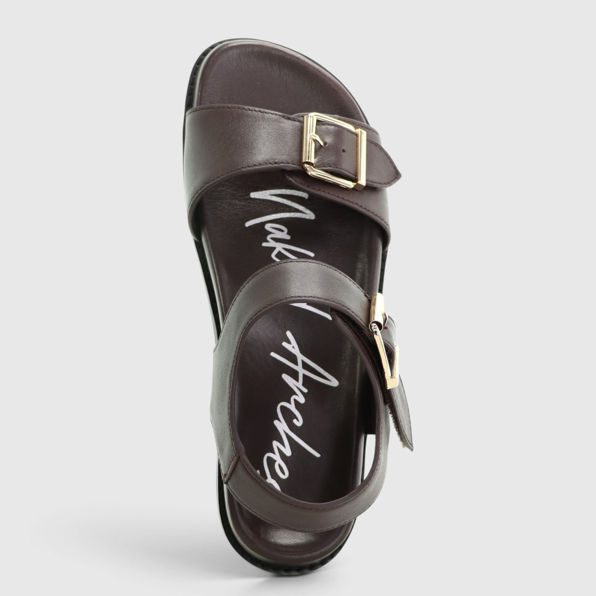 Naked Arches Ziggro chocolate sandals with textured straps and cushioned footbed on a neutral background.