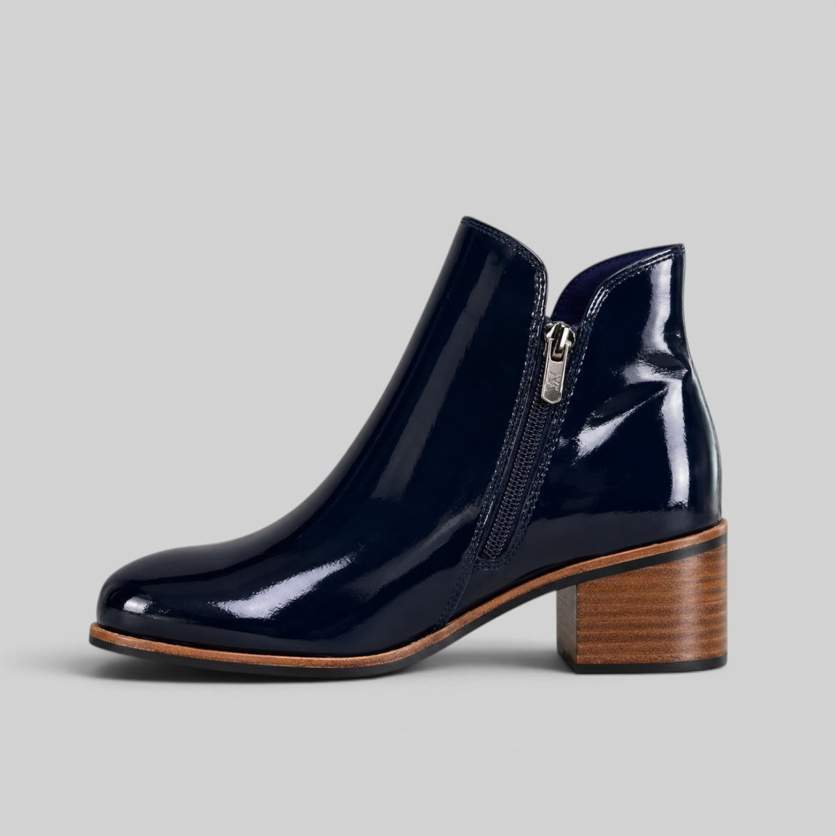 Naked Arches Oxley navy patent boots with sleek shiny finish and lace-up design, displayed on a neutral background.