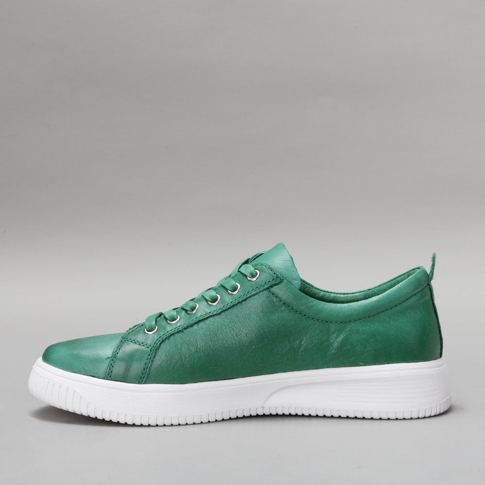 Naked Arches Nelly Jade sneakers featuring a sleek design and light green color, displayed from a side view.