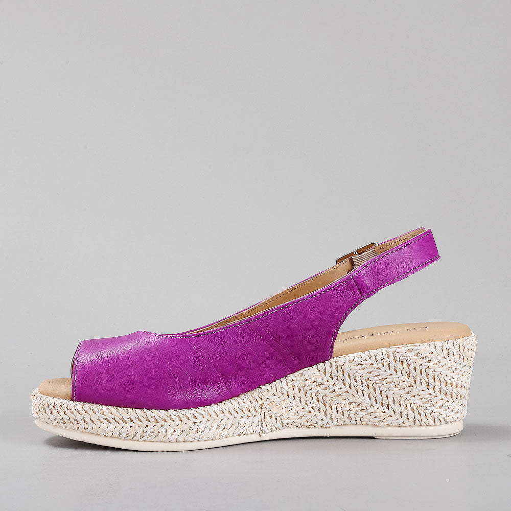 Le Sansa Petunia Purple sandals with open toes and ankle straps, featuring a stylish purple design and comfortable flat soles.