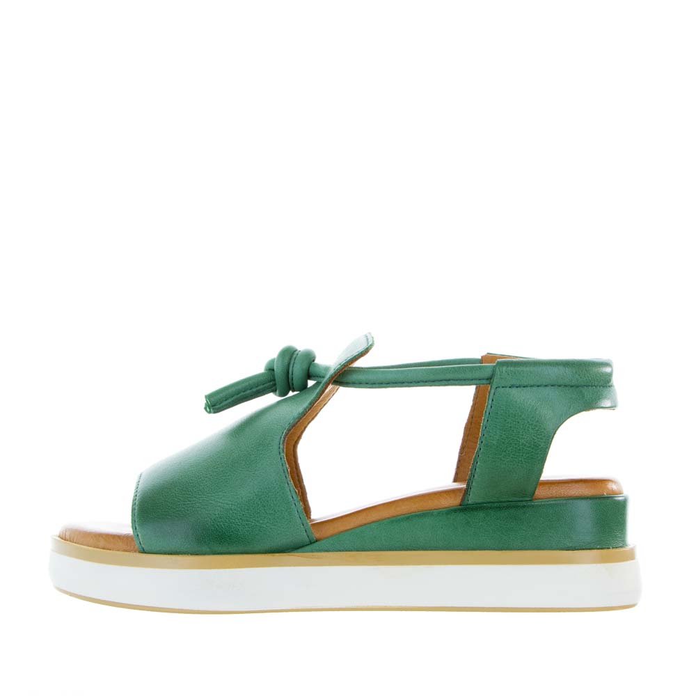 Le Sansa Hide Pine sandals featuring natural leather straps and a comfortable flat sole.