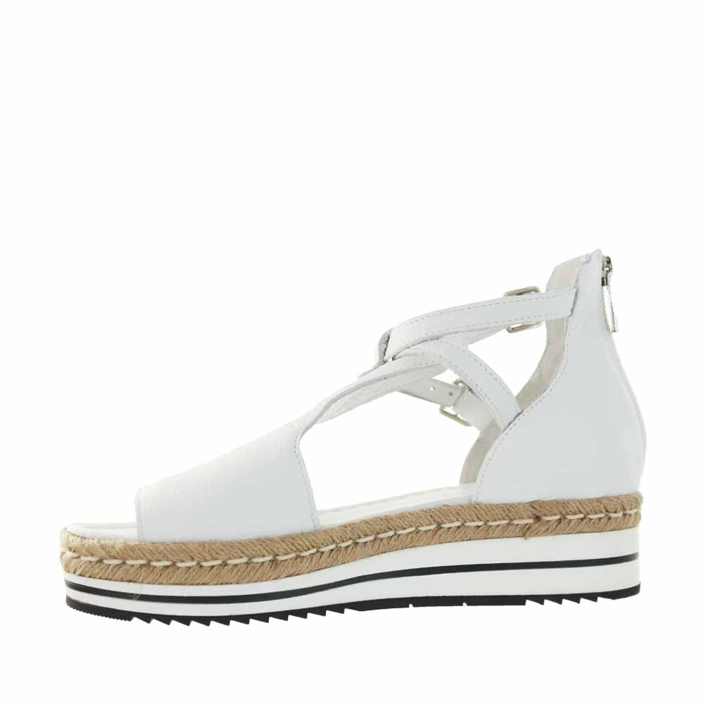 Django & Juliette Alexys white sandals with ankle straps and open toe design, stylish footwear for summer wear.