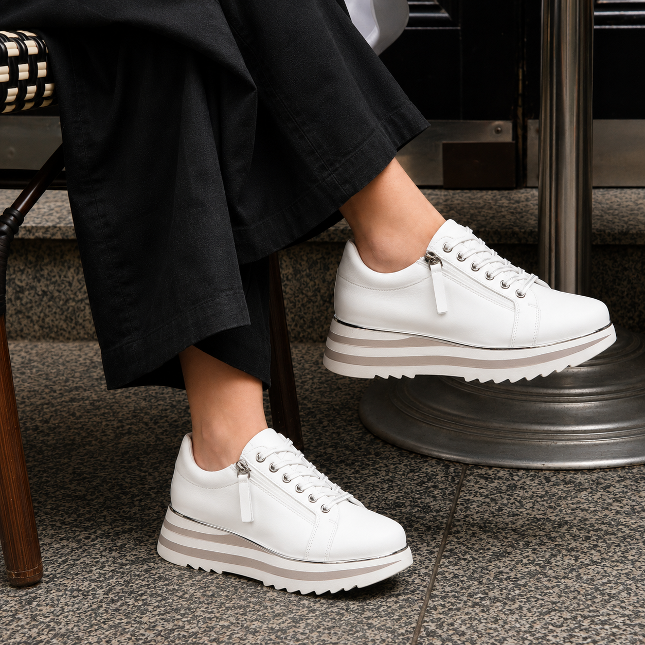 Pair of white Le Sansa Sippa sneakers with sleek design, featuring white laces and rubber soles, perfect for casual wear.