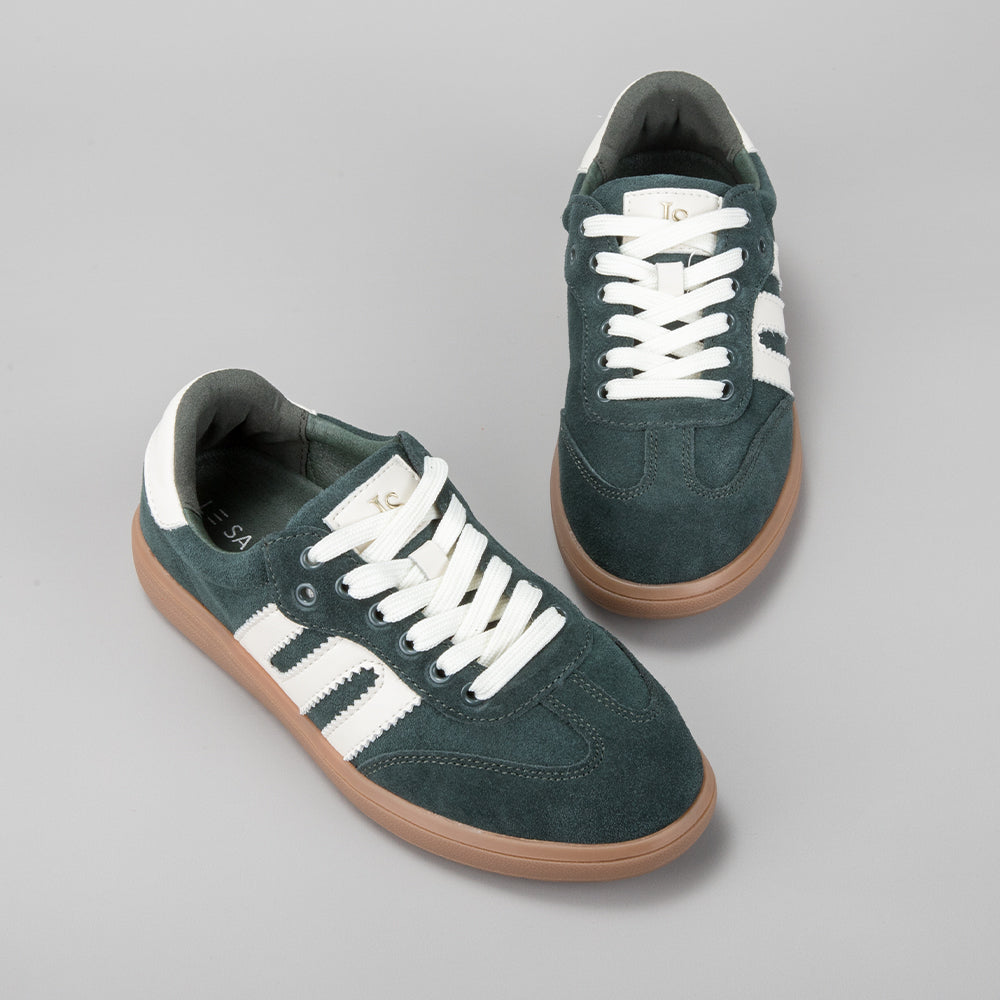Le Sansa Juno green suede sneakers with white soles and stylish design, displayed on a plain background.