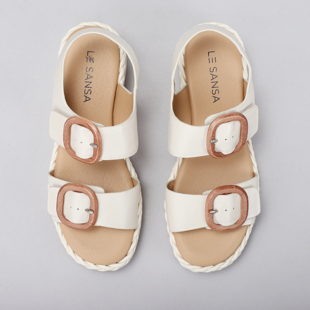 Le Sansa Sansa Emery Bone sandals featuring a strappy design and open toe in a neutral bone color.
