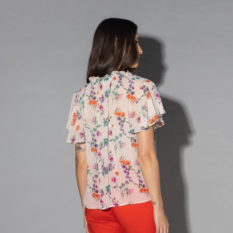 Drama The Label Flutter Blouse in summer garden print, lightweight top with ruffled accents and floral design.