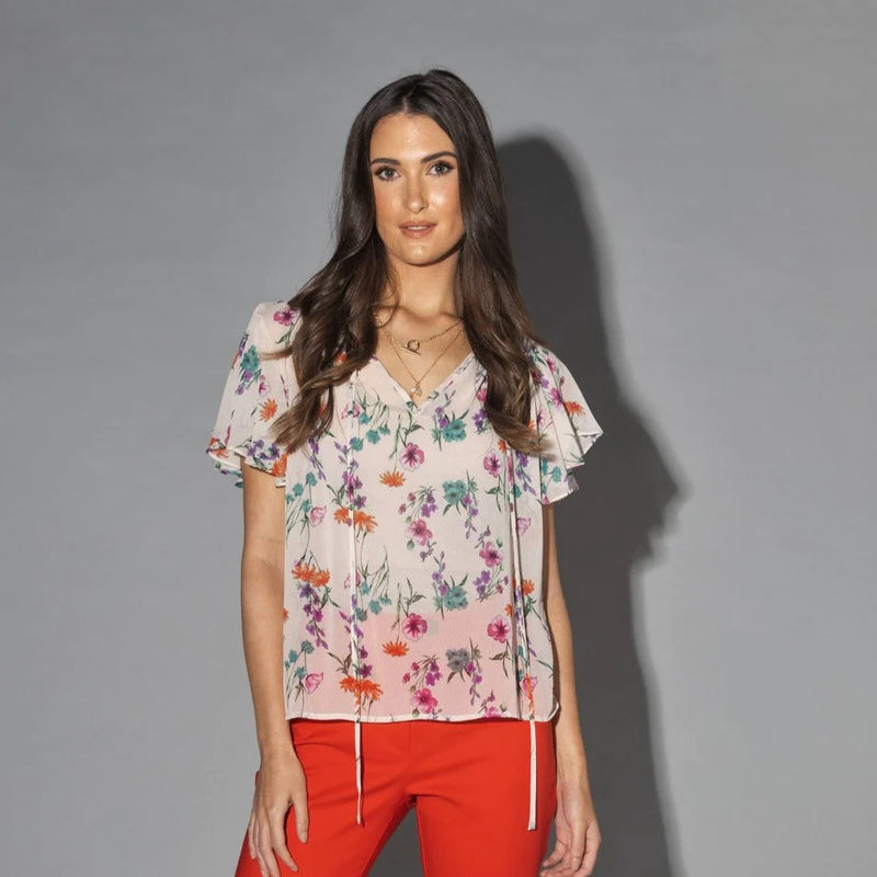 Drama The Label Flutter Blouse in Summer Garden print, lightweight top with ruffled details, perfect for warm weather.