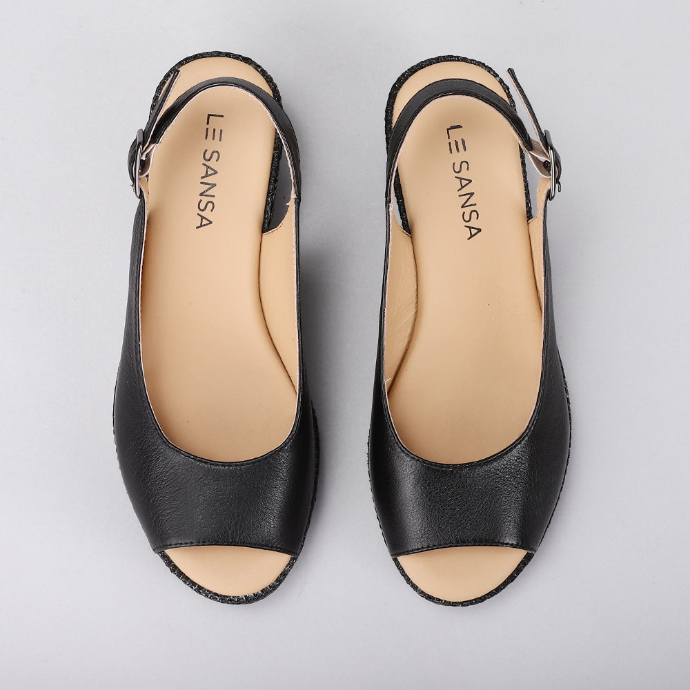 Le Sansa Petunia Black sandals with strappy design and flat sole, showcasing stylish footwear for casual wear.