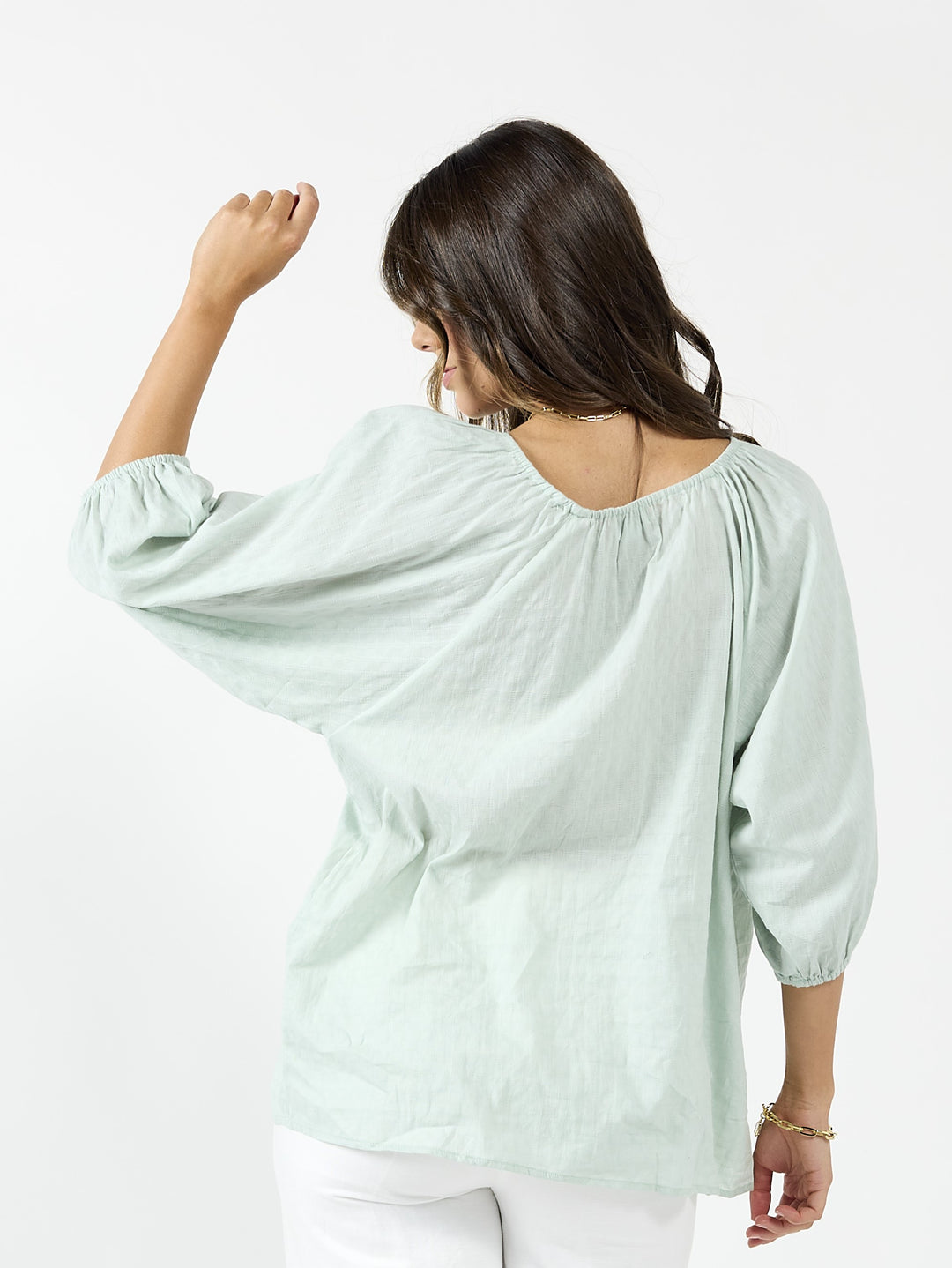 Mint green Drama The Label Milos Top, a stylish sleeveless blouse with a soft, flowy fabric and subtle ruffle details.