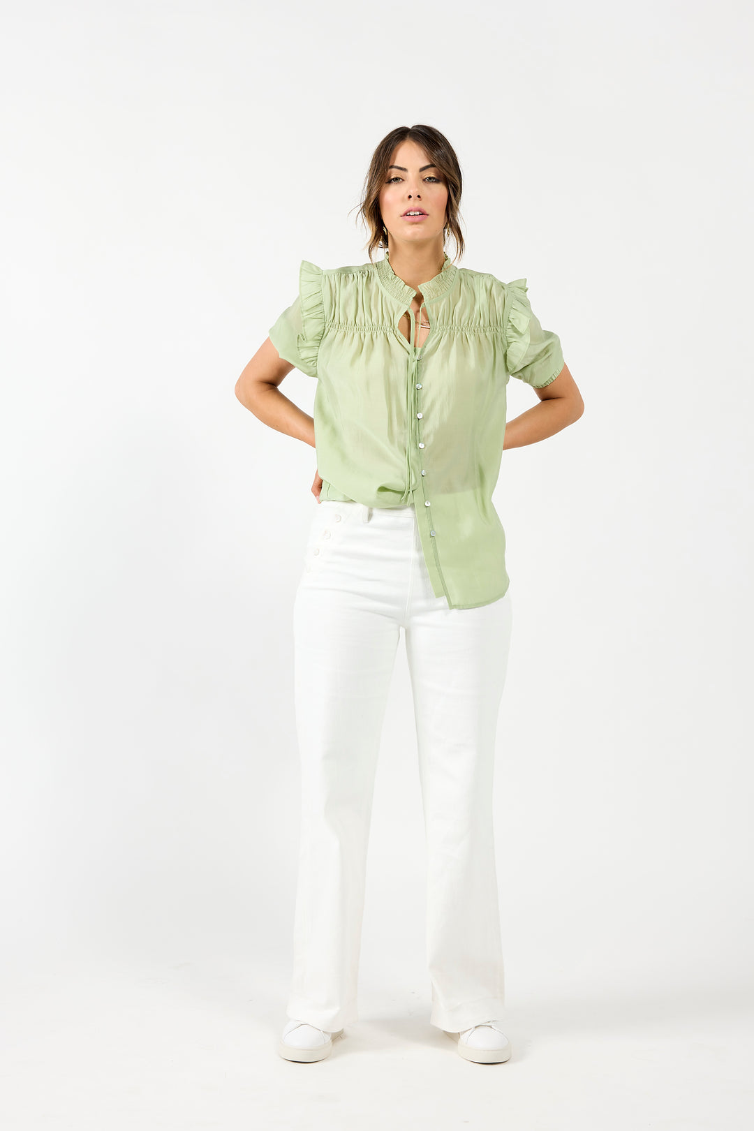 Drama The Label Bianca blouse in off-white with a sleeveless design, lightweight fabric, and subtle floral print.