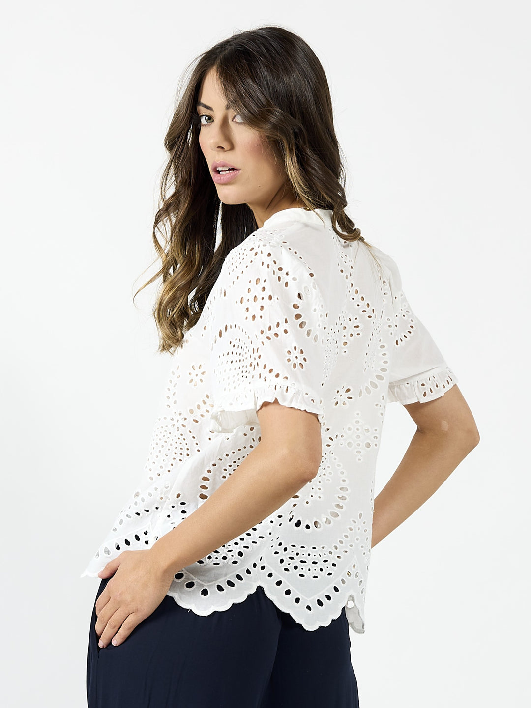 White Drama The Label Pip Top, a sleeveless blouse with a relaxed fit, shown on a model paired with Hope Indigo pants.