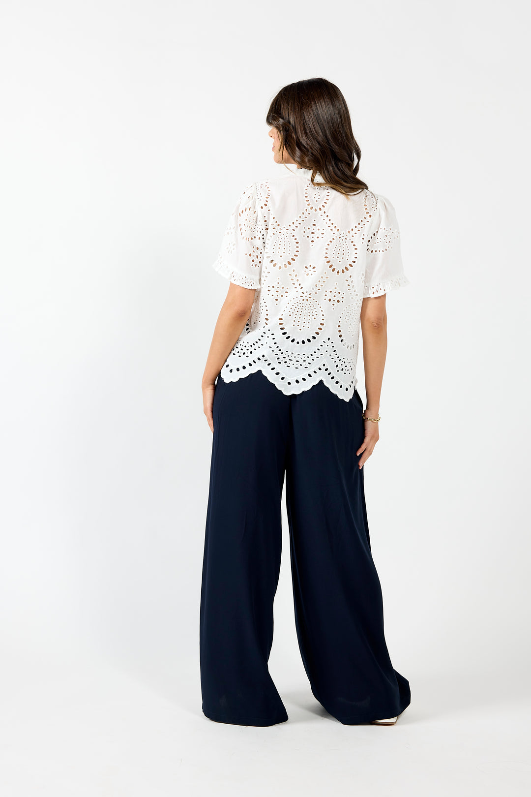 White Drama The Label Pip Top featuring a sleeveless design, lightweight fabric, and a relaxed fit, styled with blue Hope pants.