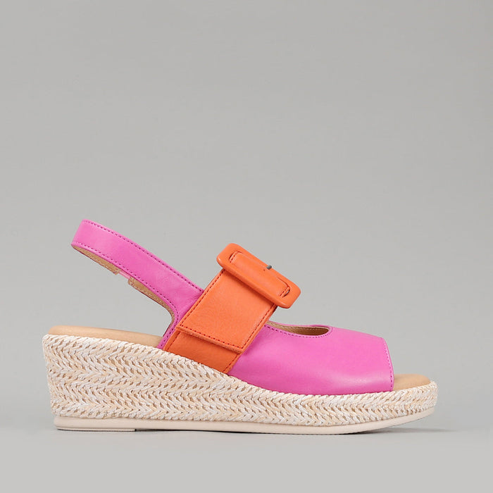 Le Sansa Parola Fuchsia Orange sandals with open toes and ankle straps, vibrant color block design on a neutral background.