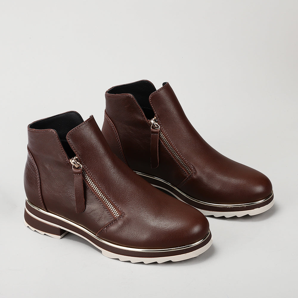 Le Sansa Basel Chocolate boots with sleek design and leather material, displayed on a neutral background.