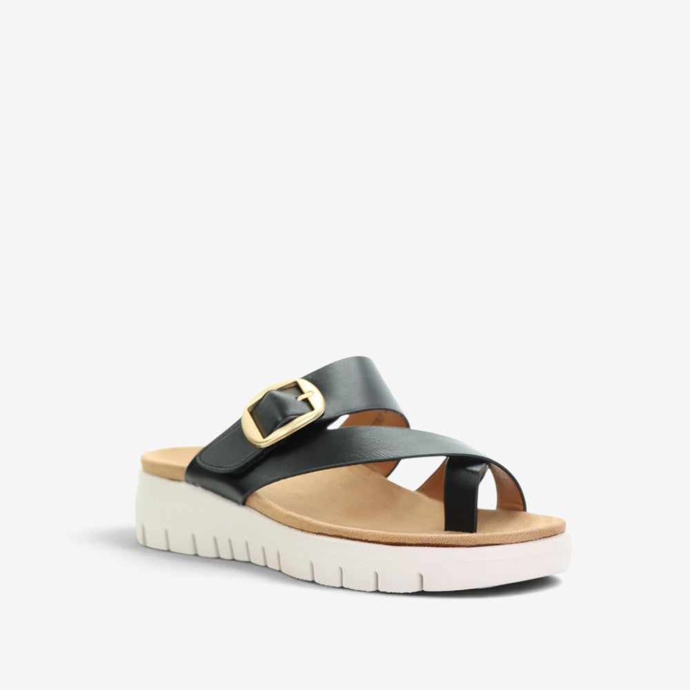 Black CC Resorts Domino slip-on shoes featuring a sleek design and comfortable fit, perfect for casual wear.