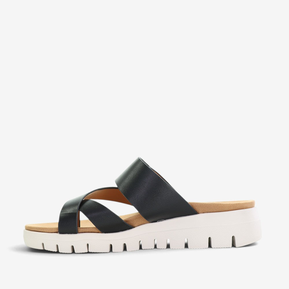 Black slip-on shoes from CC Resorts with a sleek domino pattern, designed for comfort and casual style.