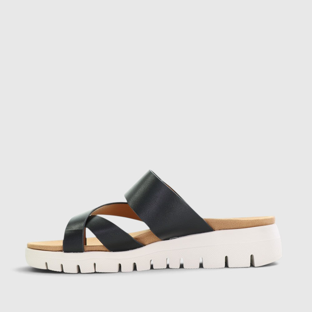 Black CC Resorts Domino slip-on shoes with sleek design and comfortable fit, perfect for casual wear.