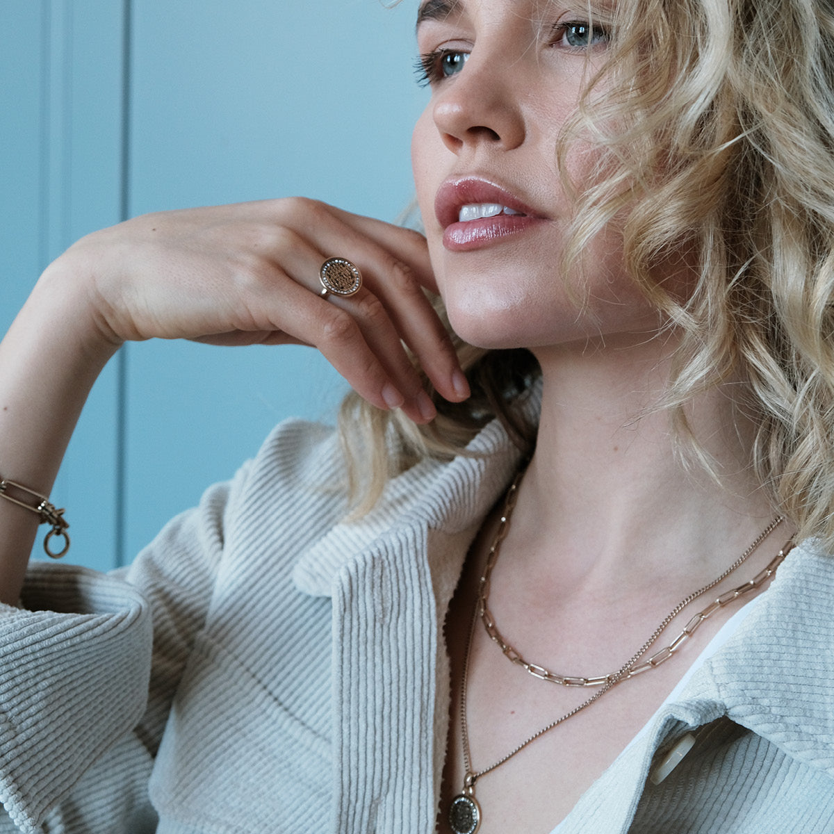 A & C Oslo Coins of Relief short chain necklace with round coin pendants, silver-tone jewelry on a plain background.