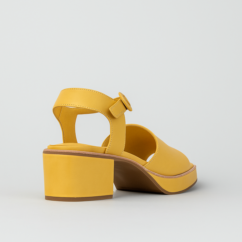 Le Sansa Sansa Ryalay mustard sandals with yellow block heels and stylish open-toe design.