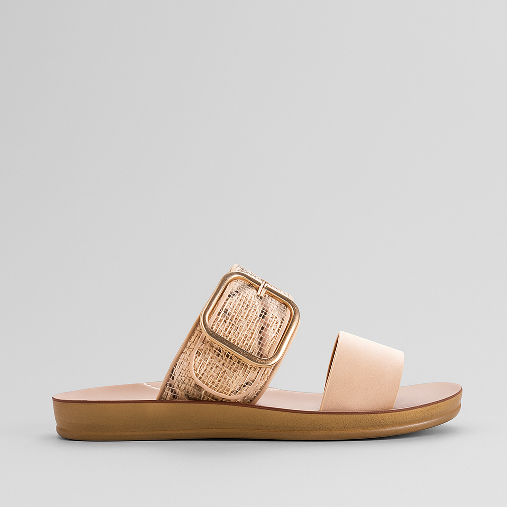 Los Cabos Doti taupe multi flats displayed on a stylish sandal stand with a textured background.