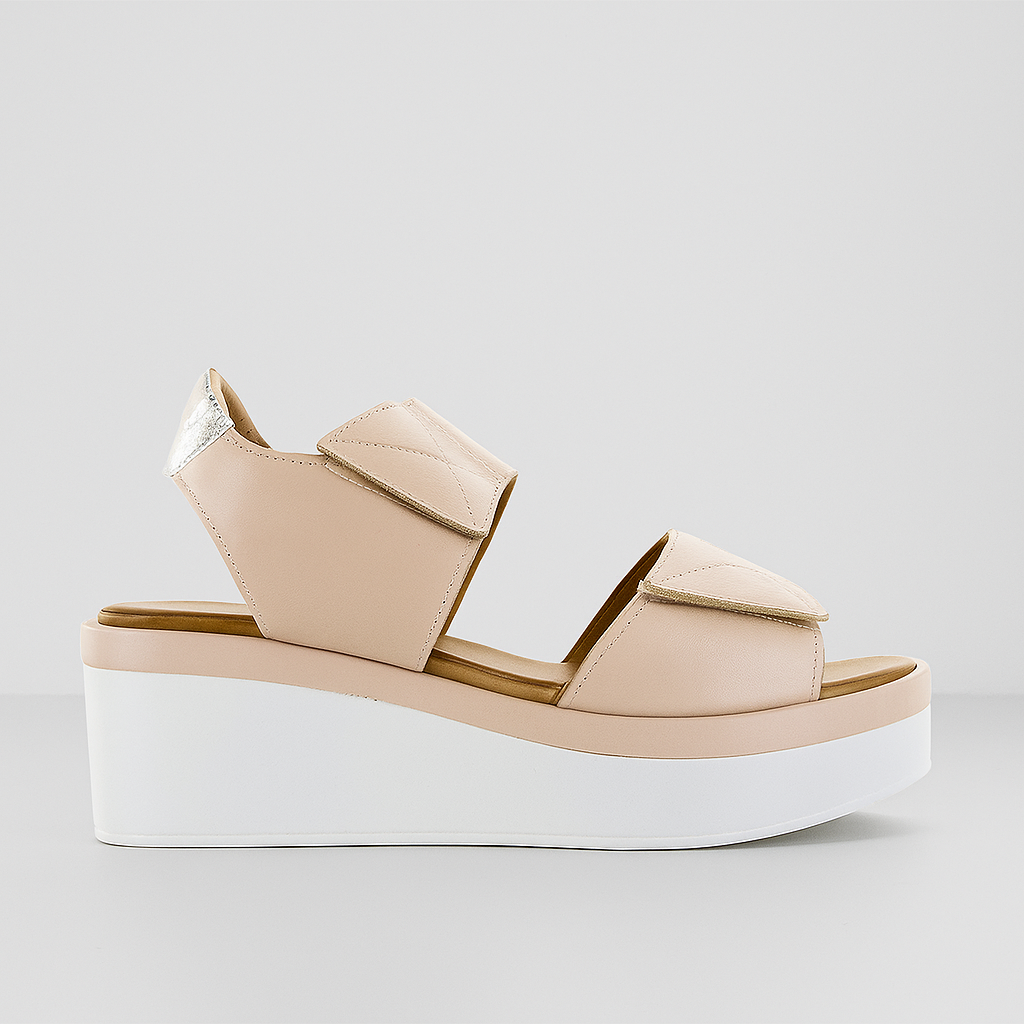 Beige wedge sandal from Le Sansa Tristen Cameo collection featuring stylish straps and comfortable design.
