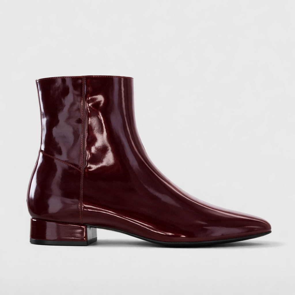 Glossy burgundy LE SANSA Sasha patent boots with a sleek design and pointed toe, perfect for stylish outfits.
