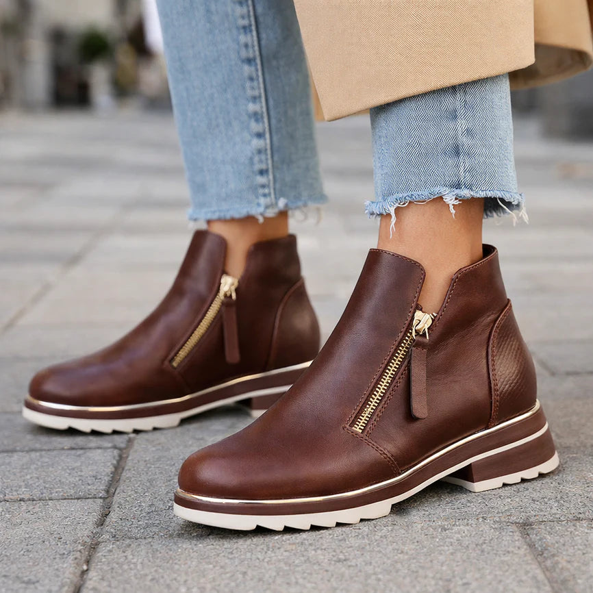 Le Sansa Basel Chocolate boots showing sleek black leather, pointed toes, and stylish ankle design.