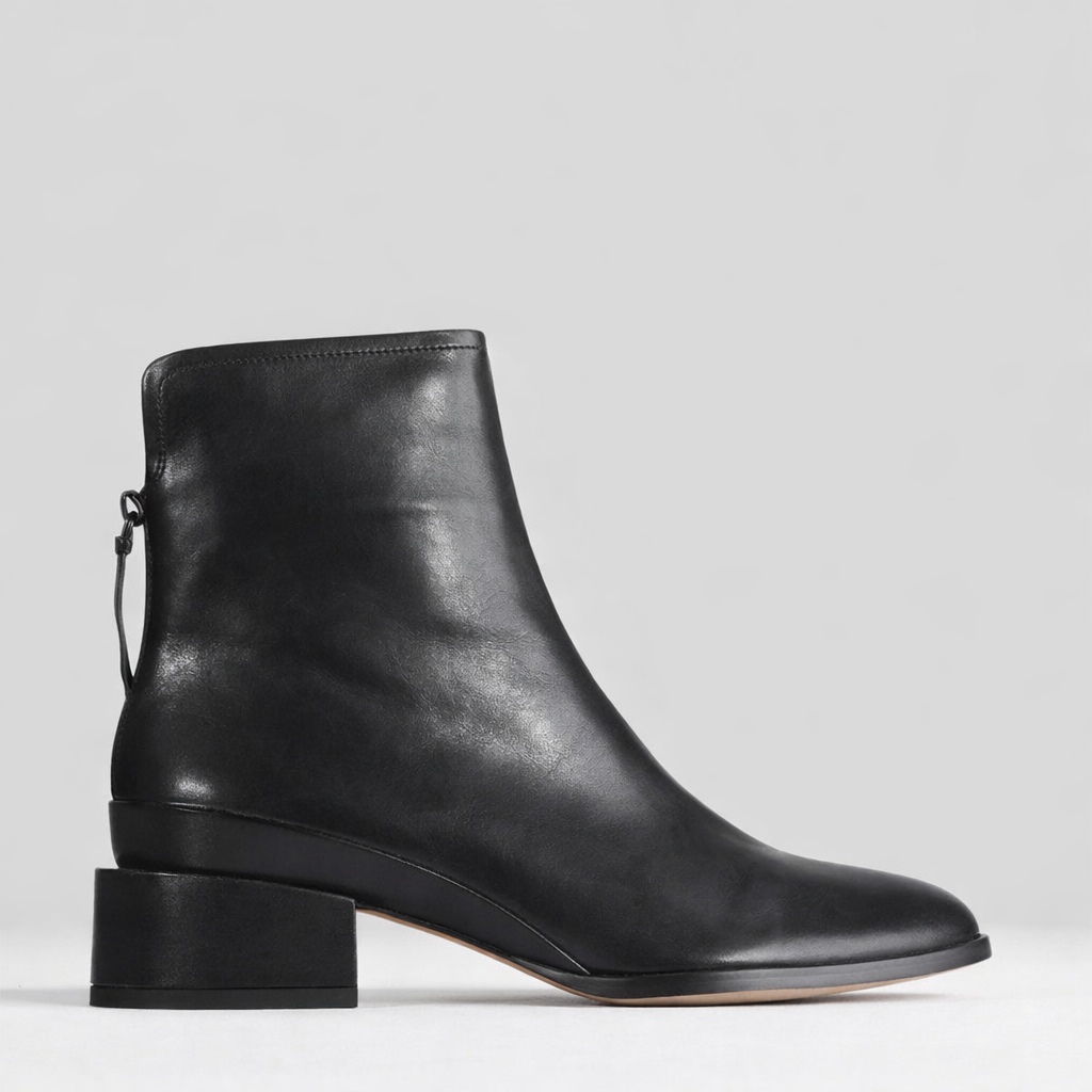 Black EOS CAST boots with chunky soles and sleek design, featuring lace-up front and metallic accents.
