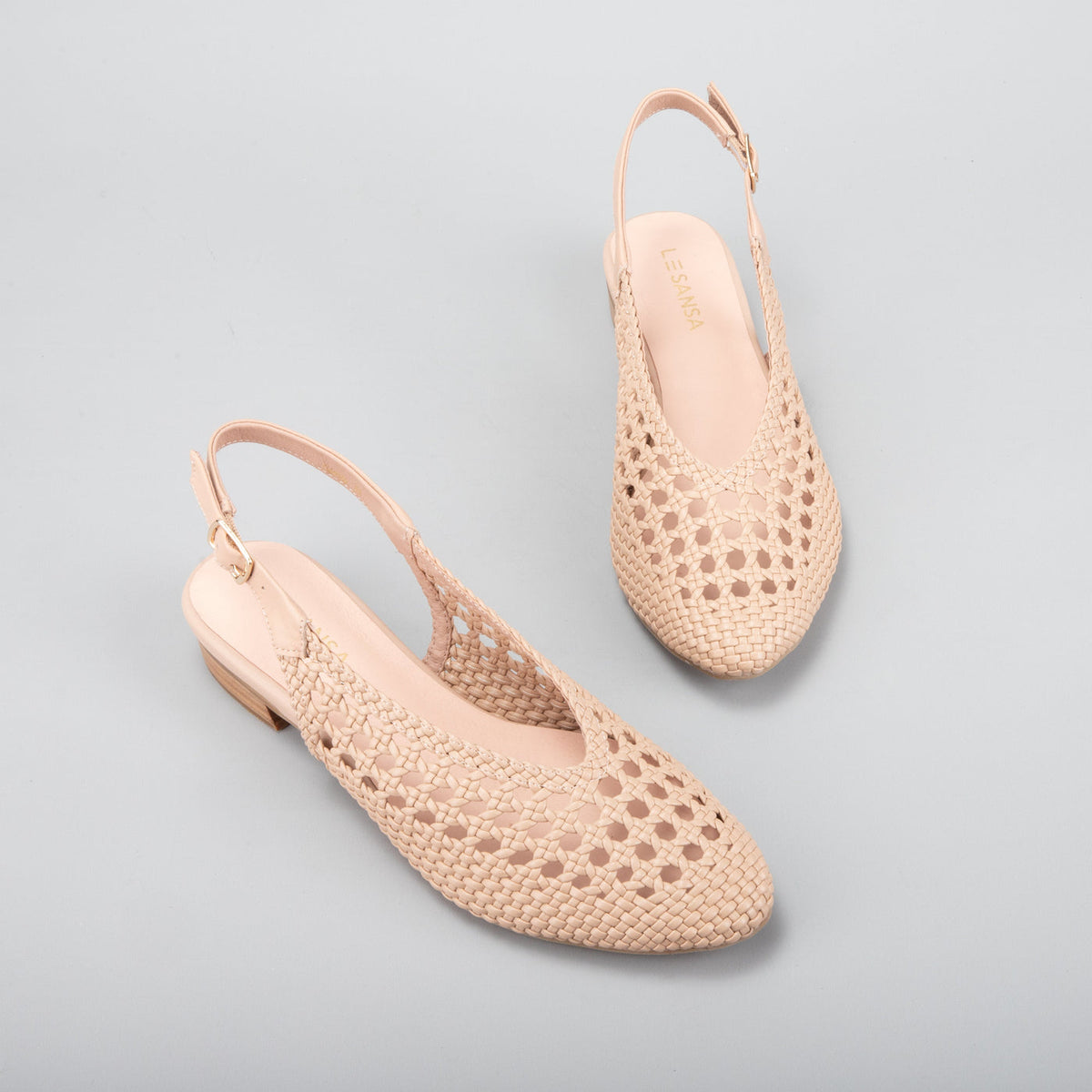 Le Sansa Camila Sandals with beige straps and flat sole, stylish footwear perfect for casual summer wear.