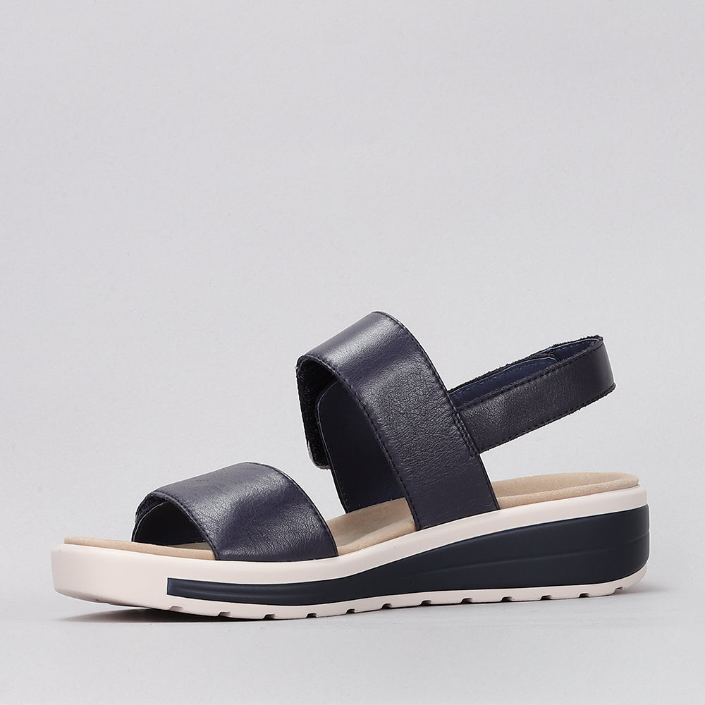 Naked Arches Hanza navy sandals with adjustable straps and cushioned soles, shown on a neutral background.