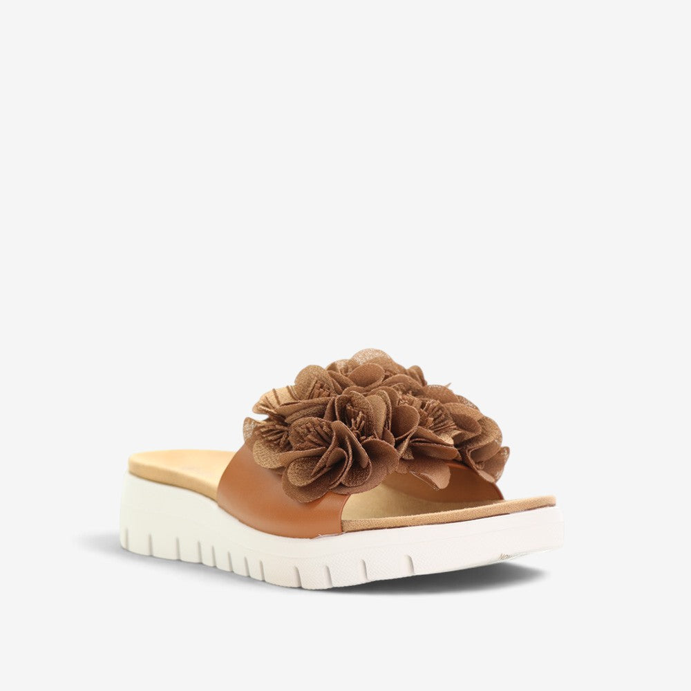 CC Resorts Domo Tan slip-on shoes, tan-colored casual footwear with a comfortable design, shown on a plain background.