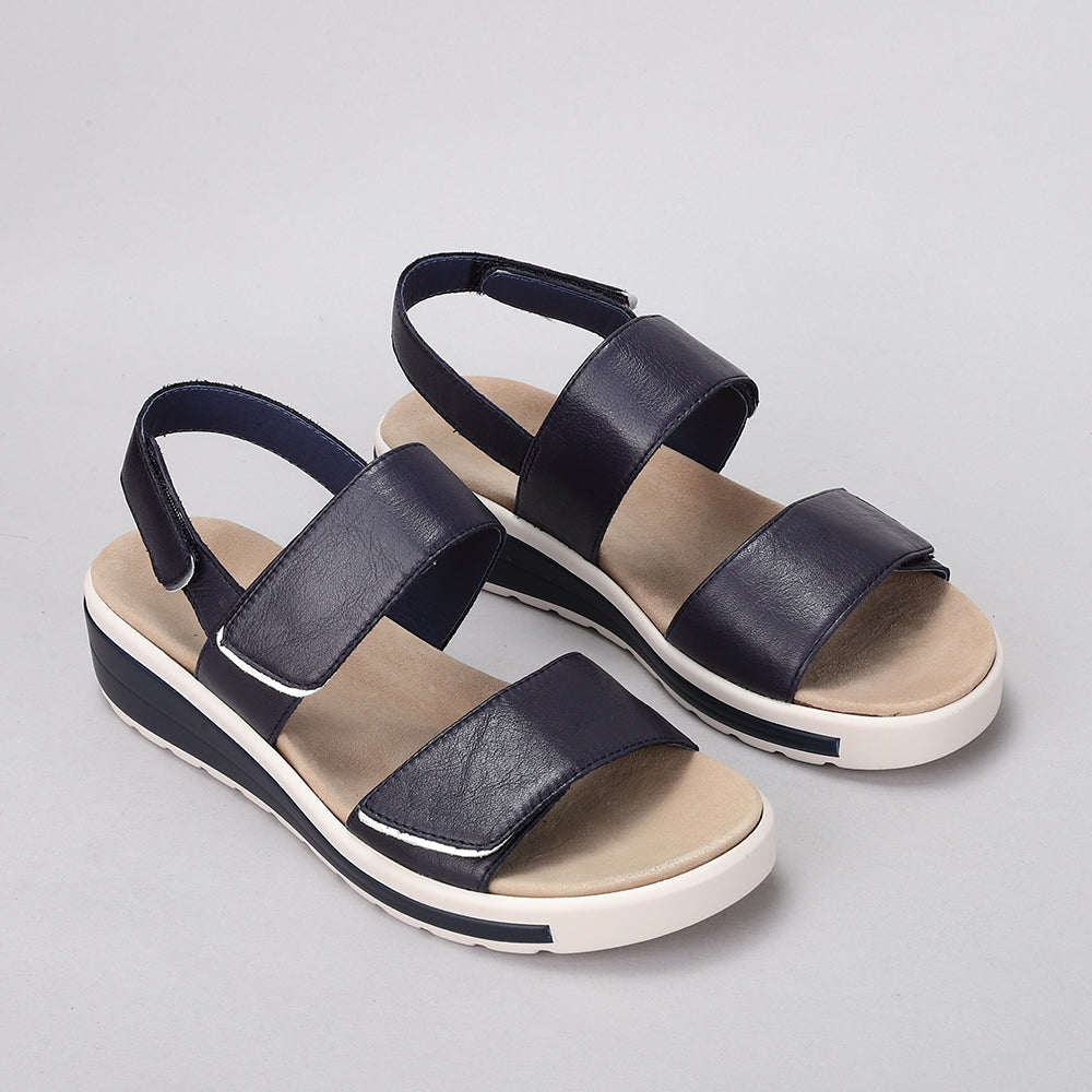 Naked Arches Hanza Navy sandals with navy straps and cushioned footbed, open-toe design, and adjustable ankle strap.