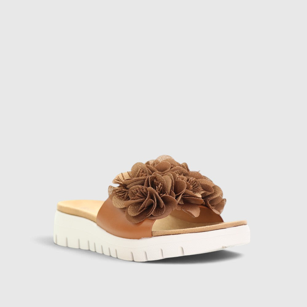 CC Resorts Domo Tan slip-on shoes with breathable fabric and casual style, perfect for comfortable everyday wear.