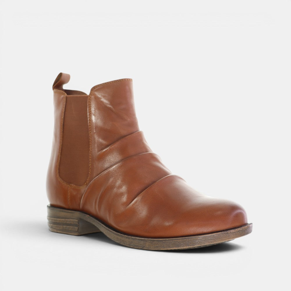 Le Sansa Lucy Tan boots with ankle-high design, leather material, and stylish slip-on style, perfect for casual or dressy outfits.