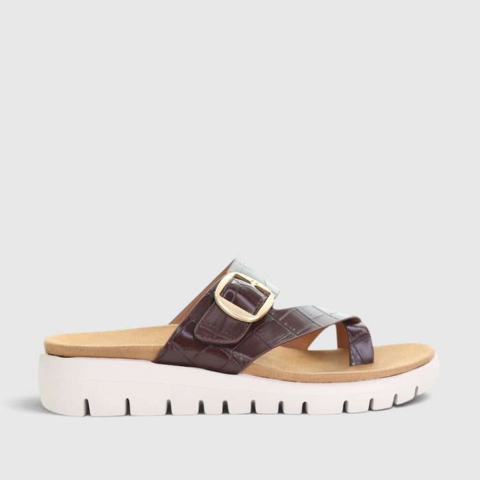 CC Resorts Domino Chocolate Crocs slip-ons featuring a chocolate brown color and comfortable casual footwear design.