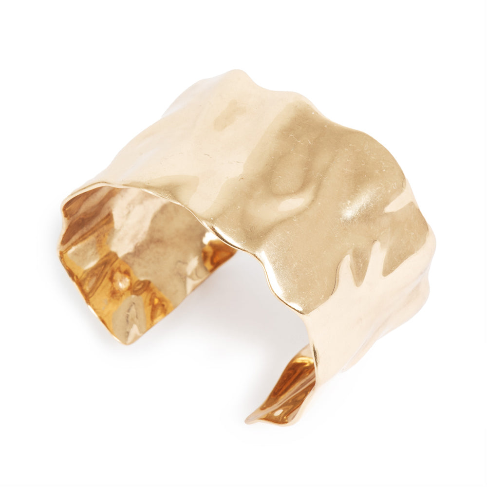 Gold sculpted cuff bracelet by A & C Oslo with a bold, artistic design featuring smooth, curved metal details.
