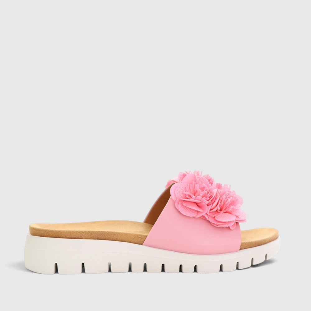 Pink CC Resorts Domo baby slip-ons for infants, featuring soft fabric and adorable Domo character design.