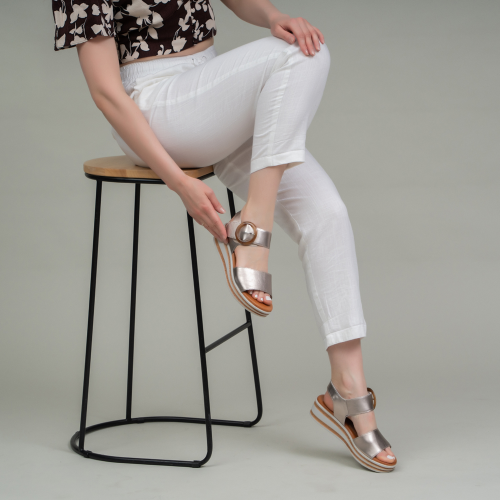Le Sansa Sansa Guard Champagne sandals featuring beige straps and a comfortable flat sole.