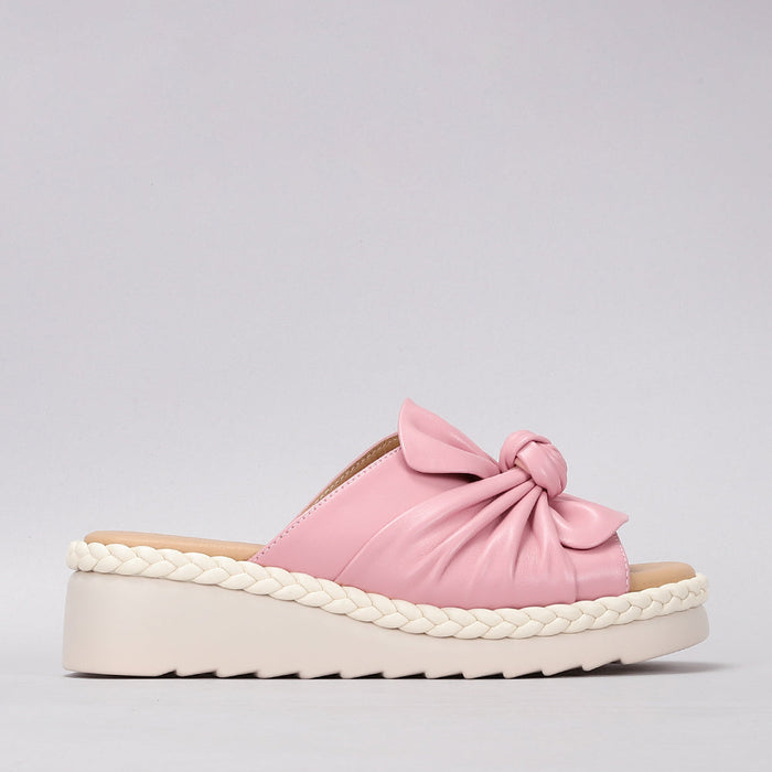 LE SANSA baby pink slip-on shoes for infants, featuring soft fabric and comfortable fit, ideal for little ones.