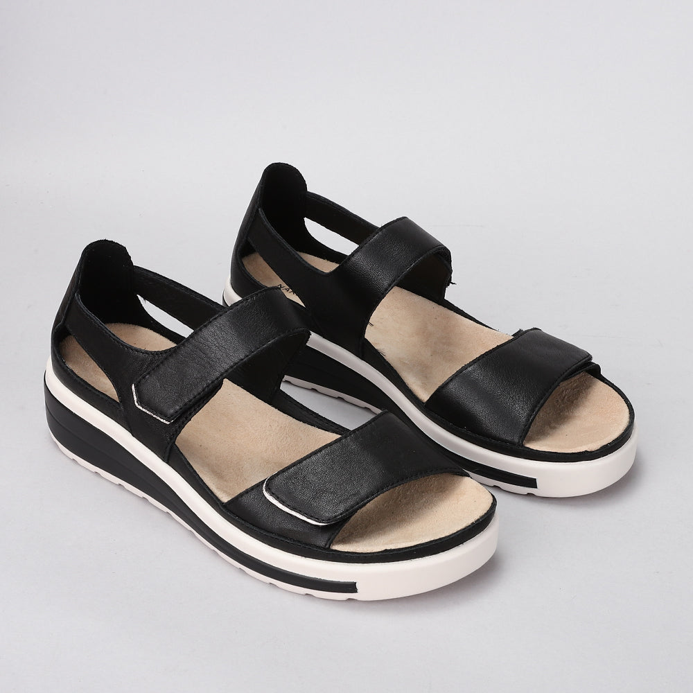 Naked Arches Happy Black sandals with open-toe design and cushioned straps, showcasing their comfortable slip-on style.