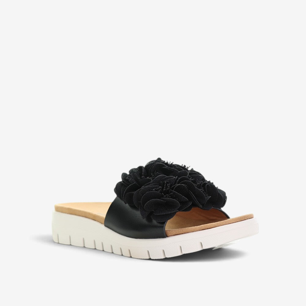 Black slip-on shoes from CC Resorts Domo collection, featuring a sleek design and comfortable fit.