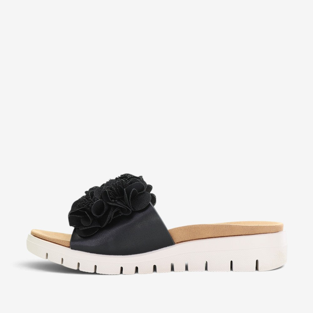 Black CC Resorts Domo slip-on shoes with sleek design, showcasing comfortable slip-on footwear in a close-up view.